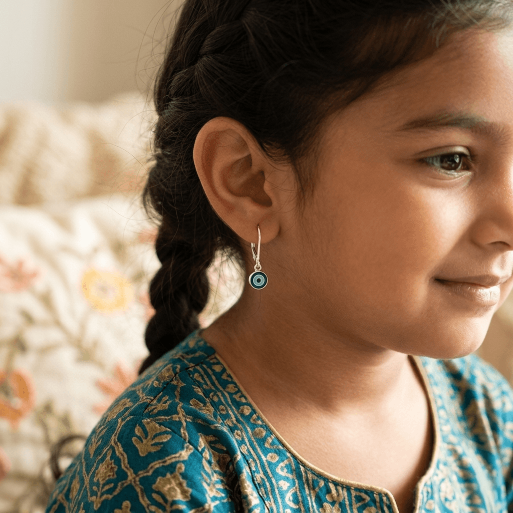 Close-up of earrings worn by girl with braided hair