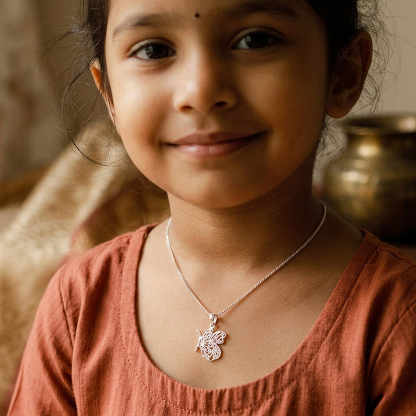 Lukachupi Titli Necklace in silver with butterfly pendant worn by girl
