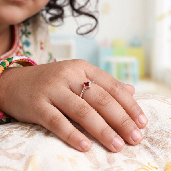 Woman wearing Star Enamel Ring on finger, sterling silver with red enamel star
