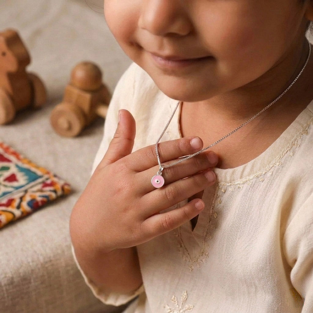 Child wearing silver enamel donut necklace