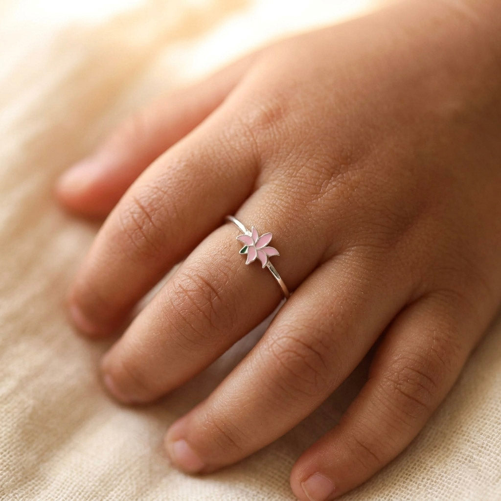 Pink Lily enamel ring worn on finger