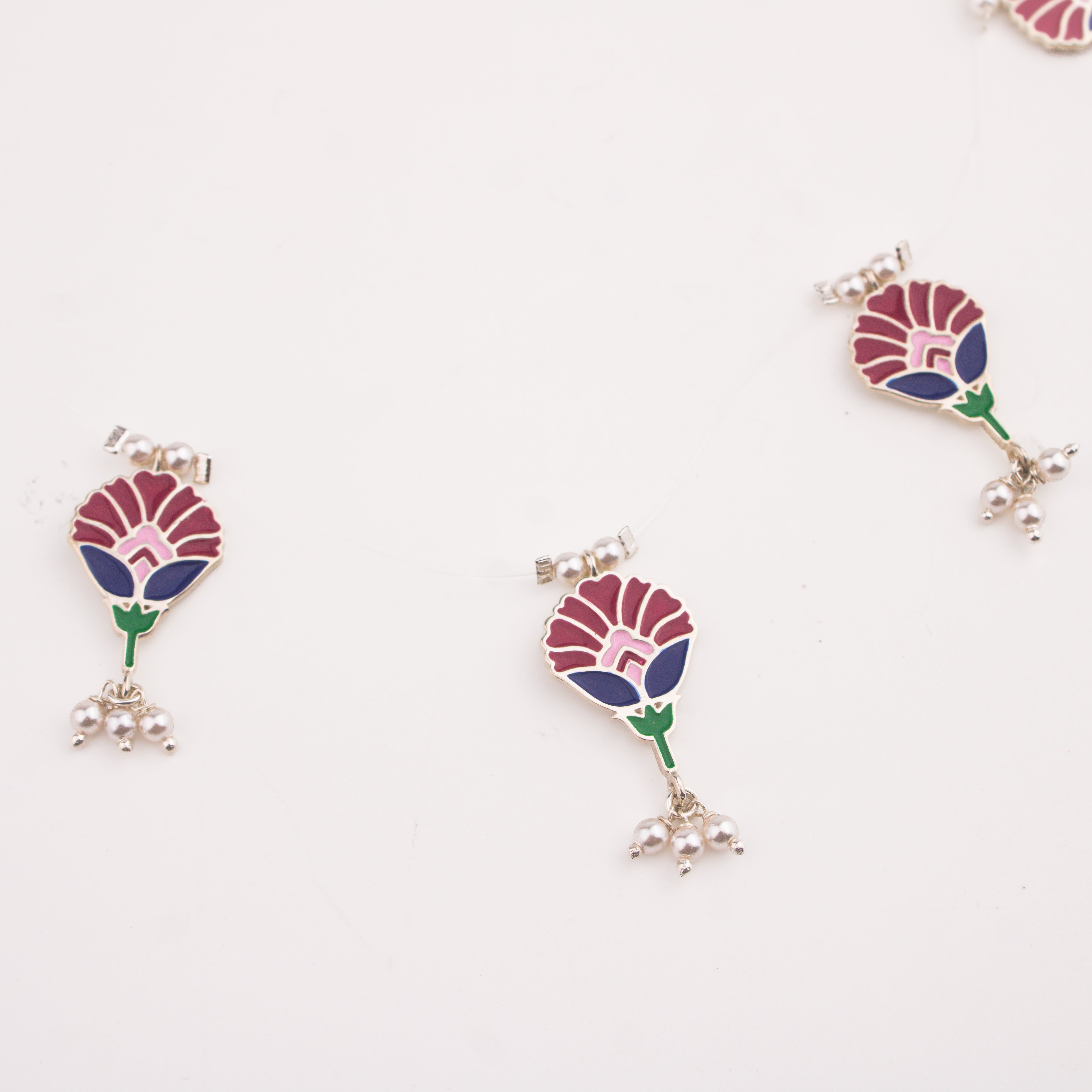 Meena charm set with invisible thread