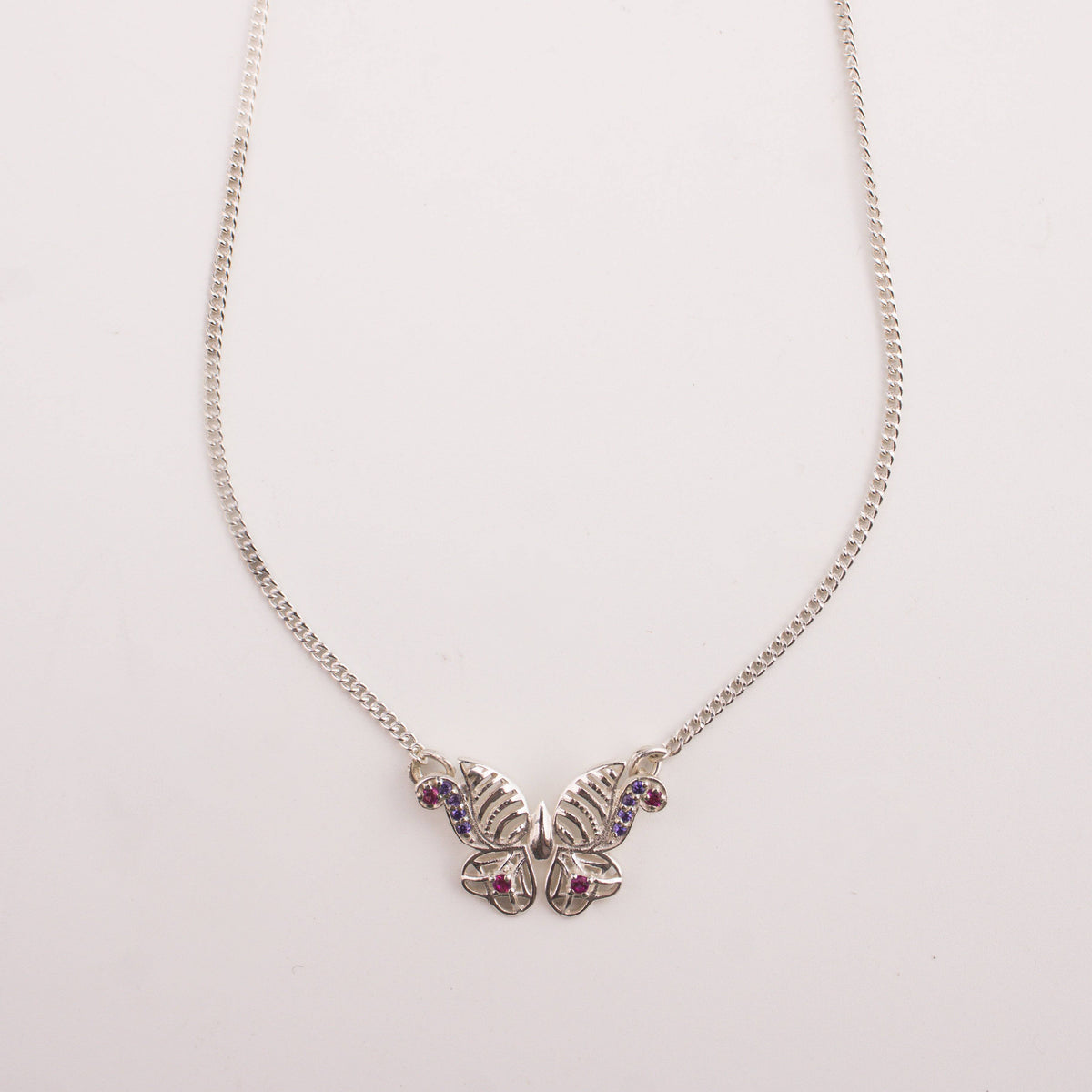 Elegant silver butterfly pendant necklace on model