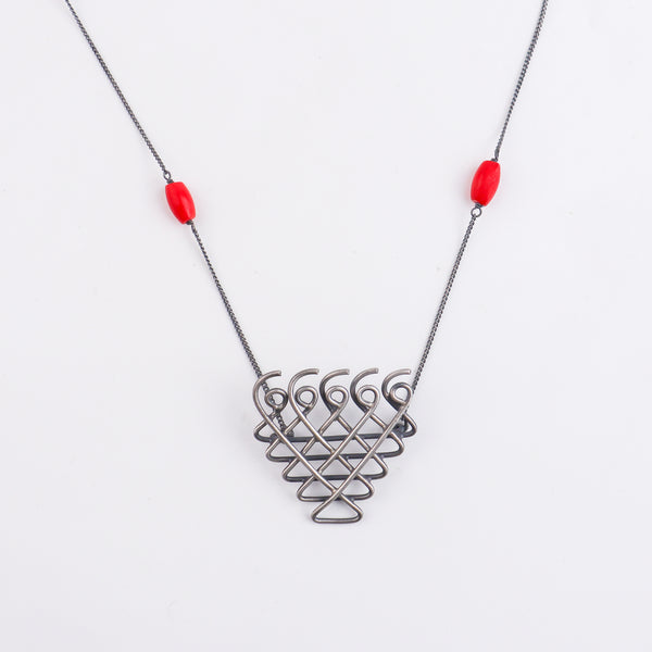 Angled view of Silver Saraswati Necklace with Coral Small
