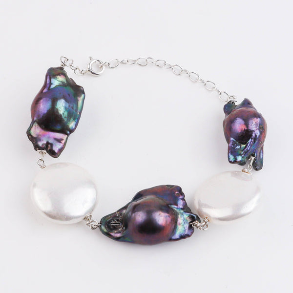 Angled side view of 92.5 silver pearl Ganthan bracelet showing adjustable chain and pearl alignment