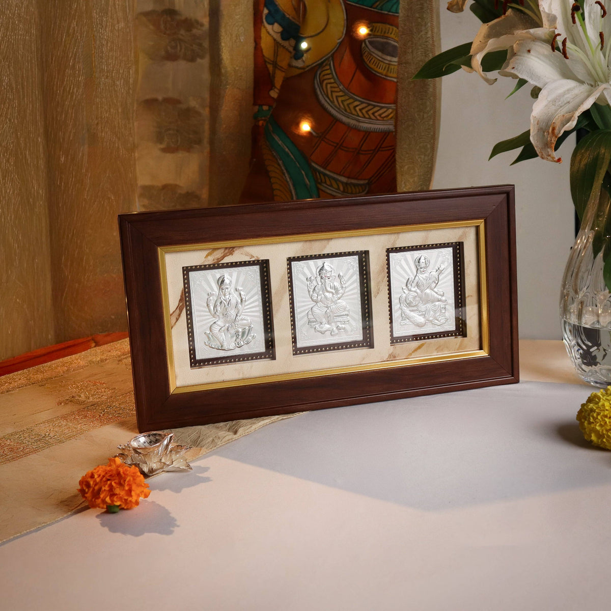 Big silver triple deity frame with Lakshmi, Ganpati & Saraswati for home decor