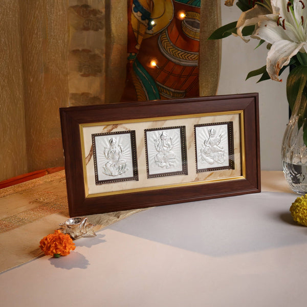Big silver triple deity frame with Lakshmi, Ganpati & Saraswati for home decor