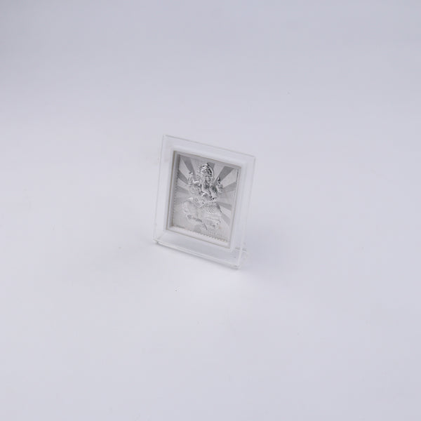 Side view of silver Ganapati idol in acrylic frame