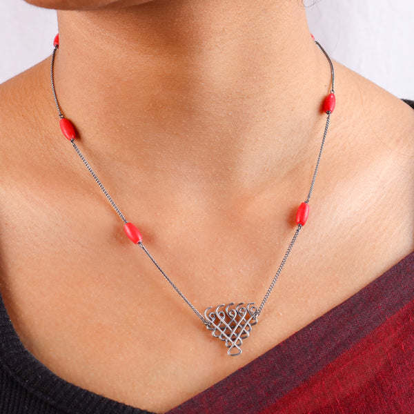 Close-up of Silver Saraswati Necklace with coral detailing