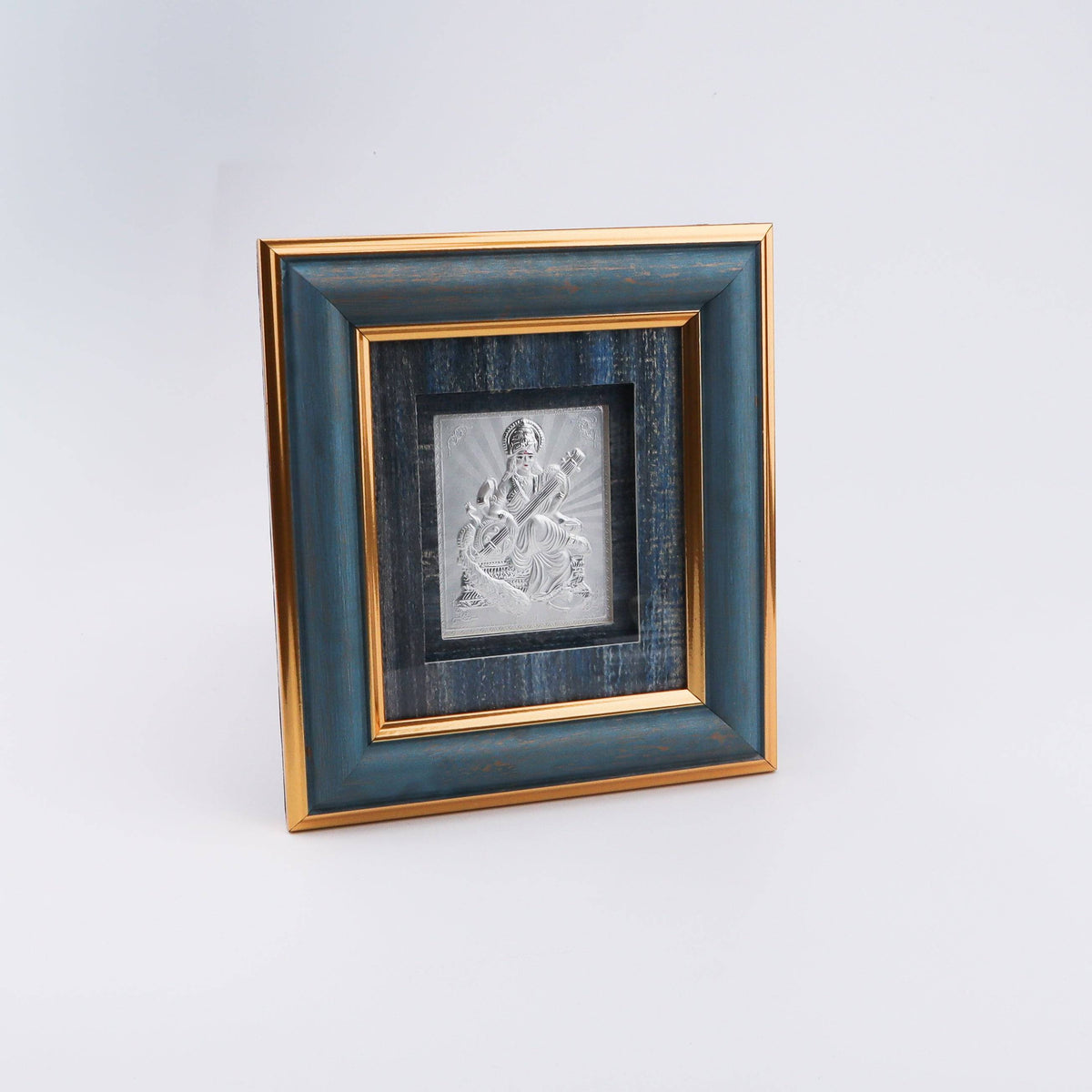 Elegant silver Saraswati Devi picture frame with blue and gold accents