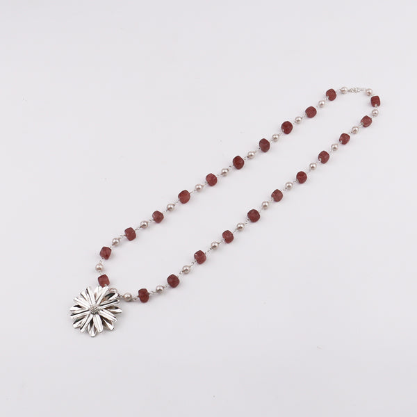Detail shot of Soorajmukhi motif and pink strawberry cube beads