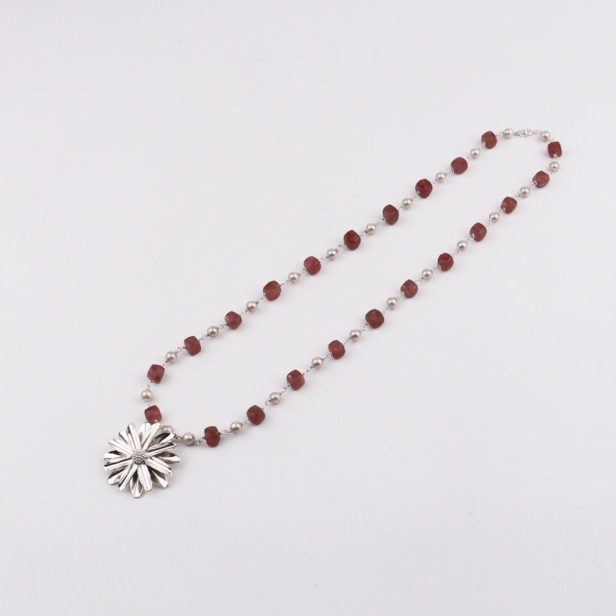 Detail shot of Soorajmukhi motif and pink strawberry cube beads