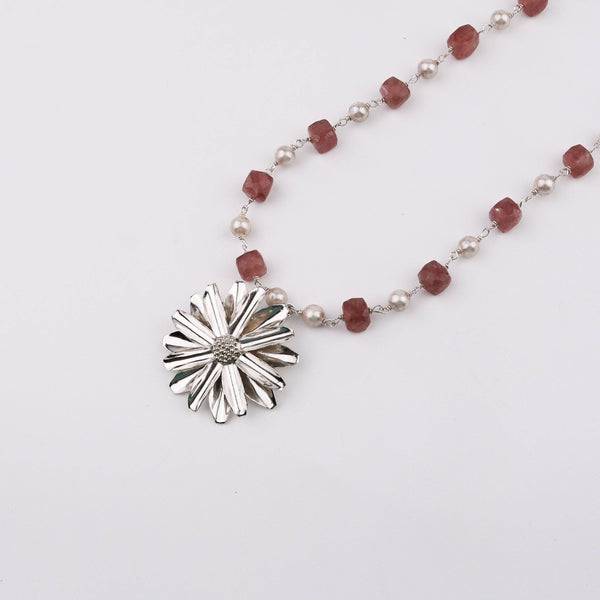 Close-up of Silver Soorajmukhi Pendant with pink strawberry cubes