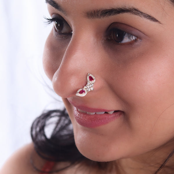 Woman wearing silver Nath with pink drop CZ stones nose pin