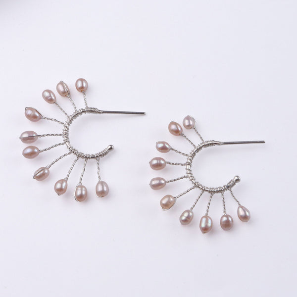 Close-up of Rice Pearl Snowflake Hoops showcasing natural rice pearls, intricate snowflake design, and handmade silver craftsmanship