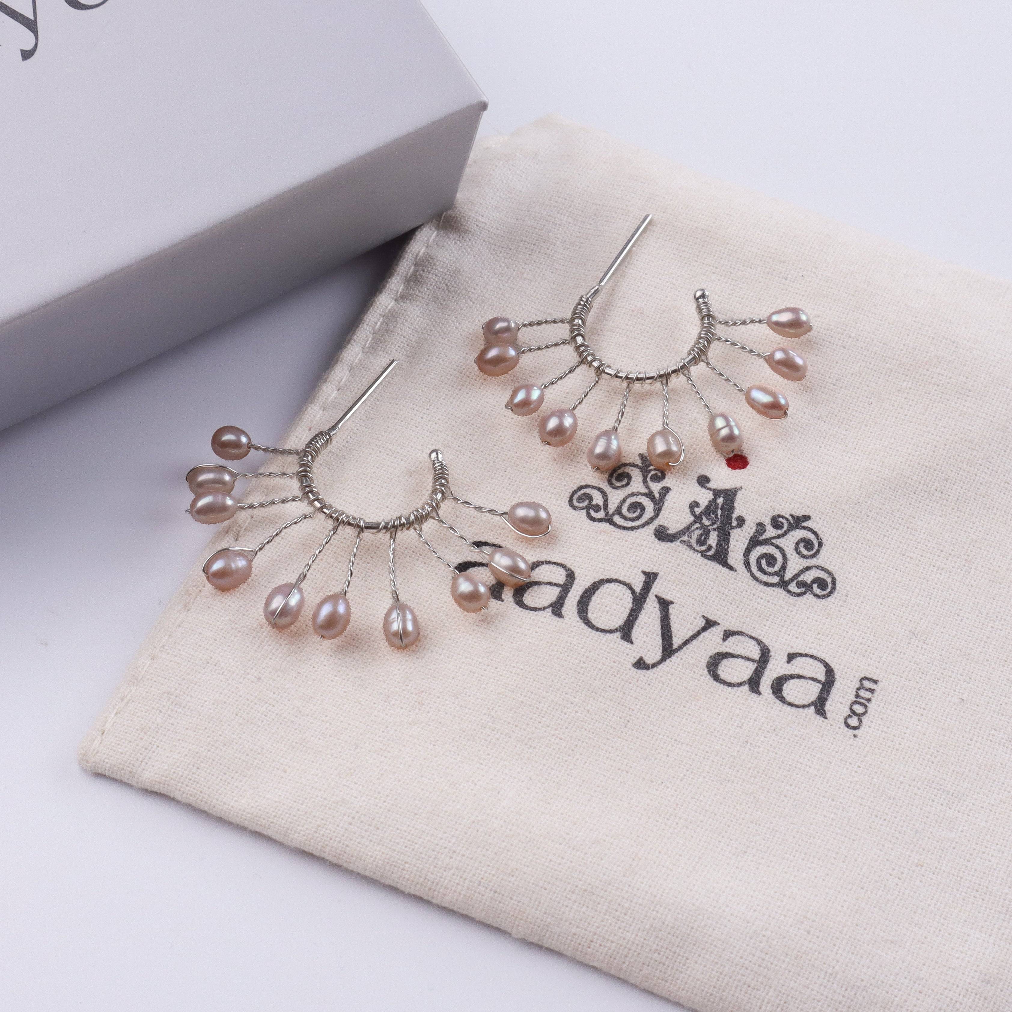 Detailed view of Rice Pearl Snowflake Hoops highlighting lustrous rice pearls, intricate snowflake motifs, and polished silver finish