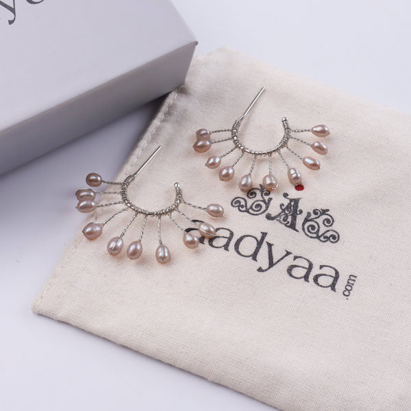 Detailed view of Rice Pearl Snowflake Hoops highlighting lustrous rice pearls, intricate snowflake motifs, and polished silver finish