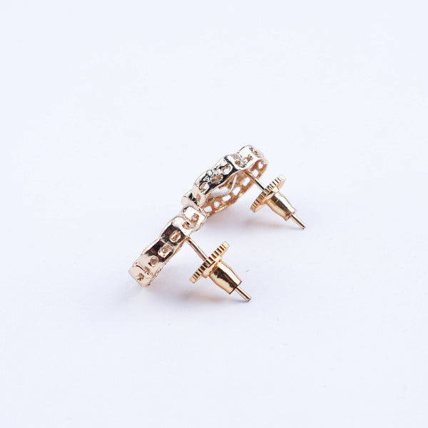 Angled view of a 22K gold-plated fashion earring highlighting its elegant silhouette, structure, and polished gold finish