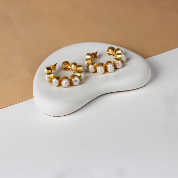 Angled view of a 22K gold-plated fashion earring highlighting its elegant silhouette, structure, and polished gold finish