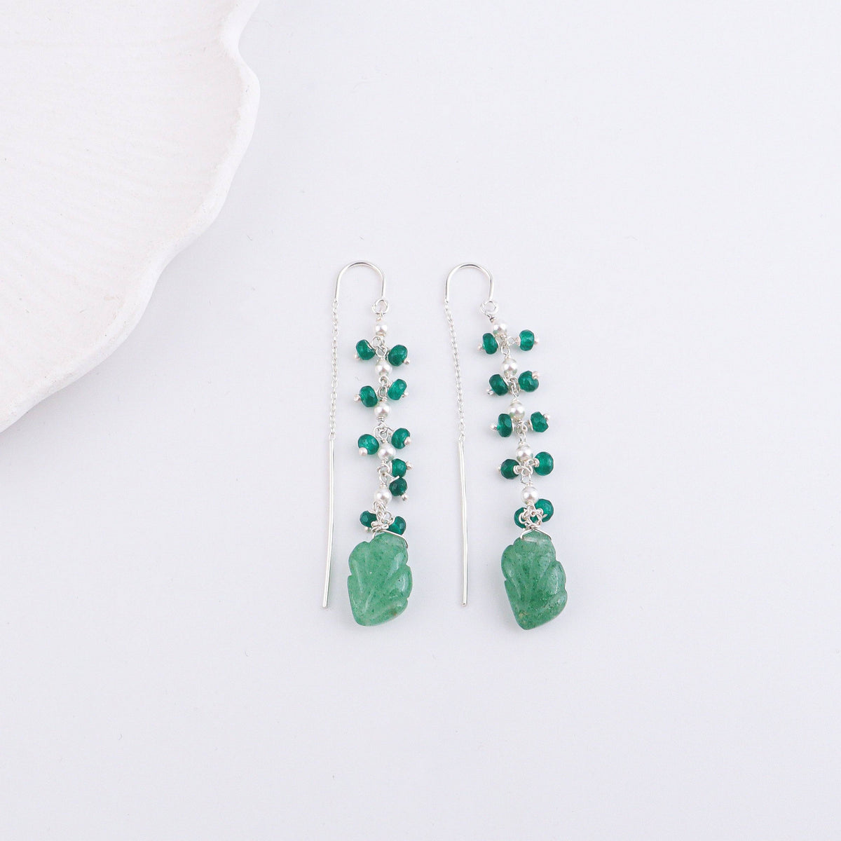 Flat-lay of Russian Quartz & Green Onyx Sui Dhaaga Branch Earrings with complementary jewelry and elegant accessories