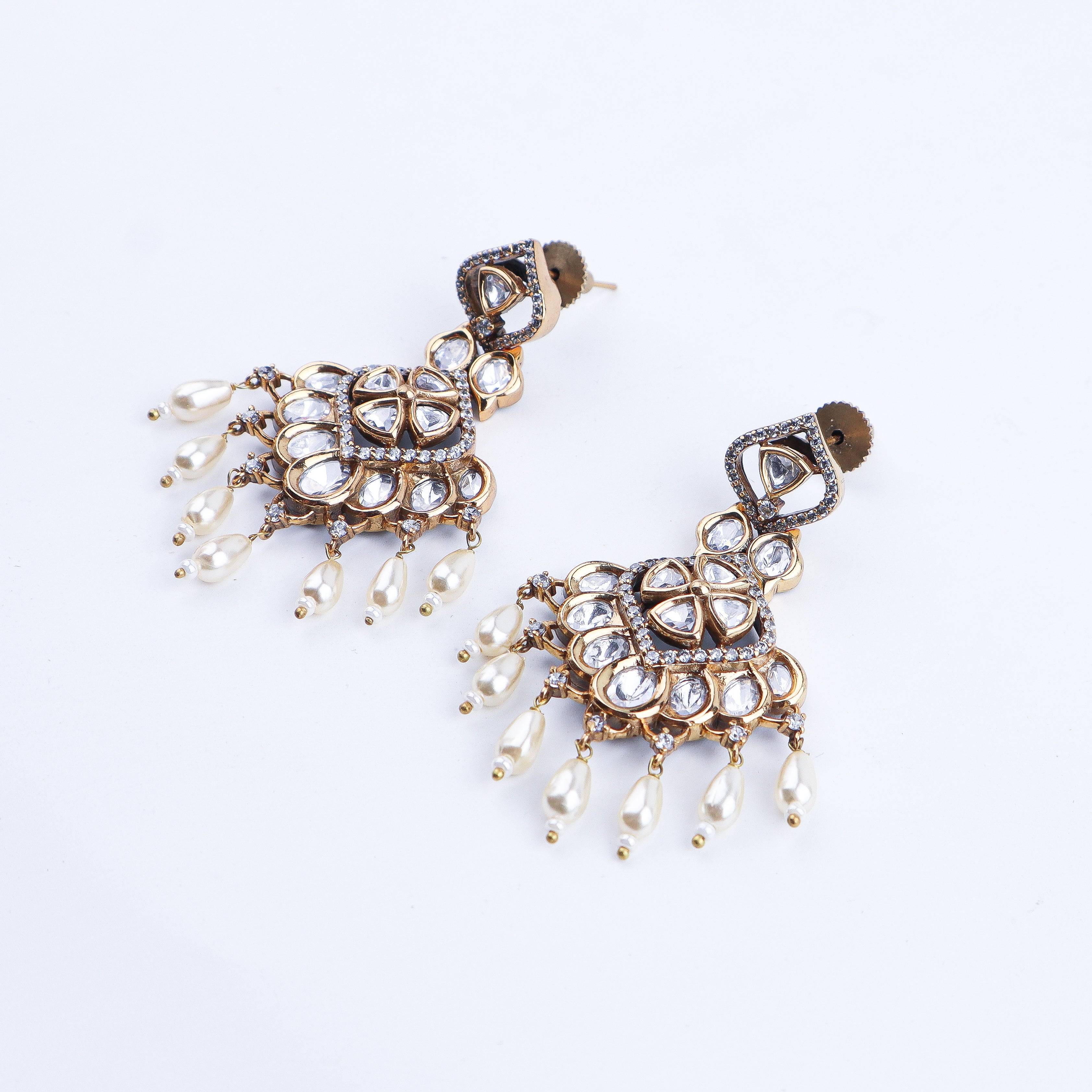 Angled view of a 22K gold-plated fashion earring highlighting its elegant silhouette, structure, and polished gold finish