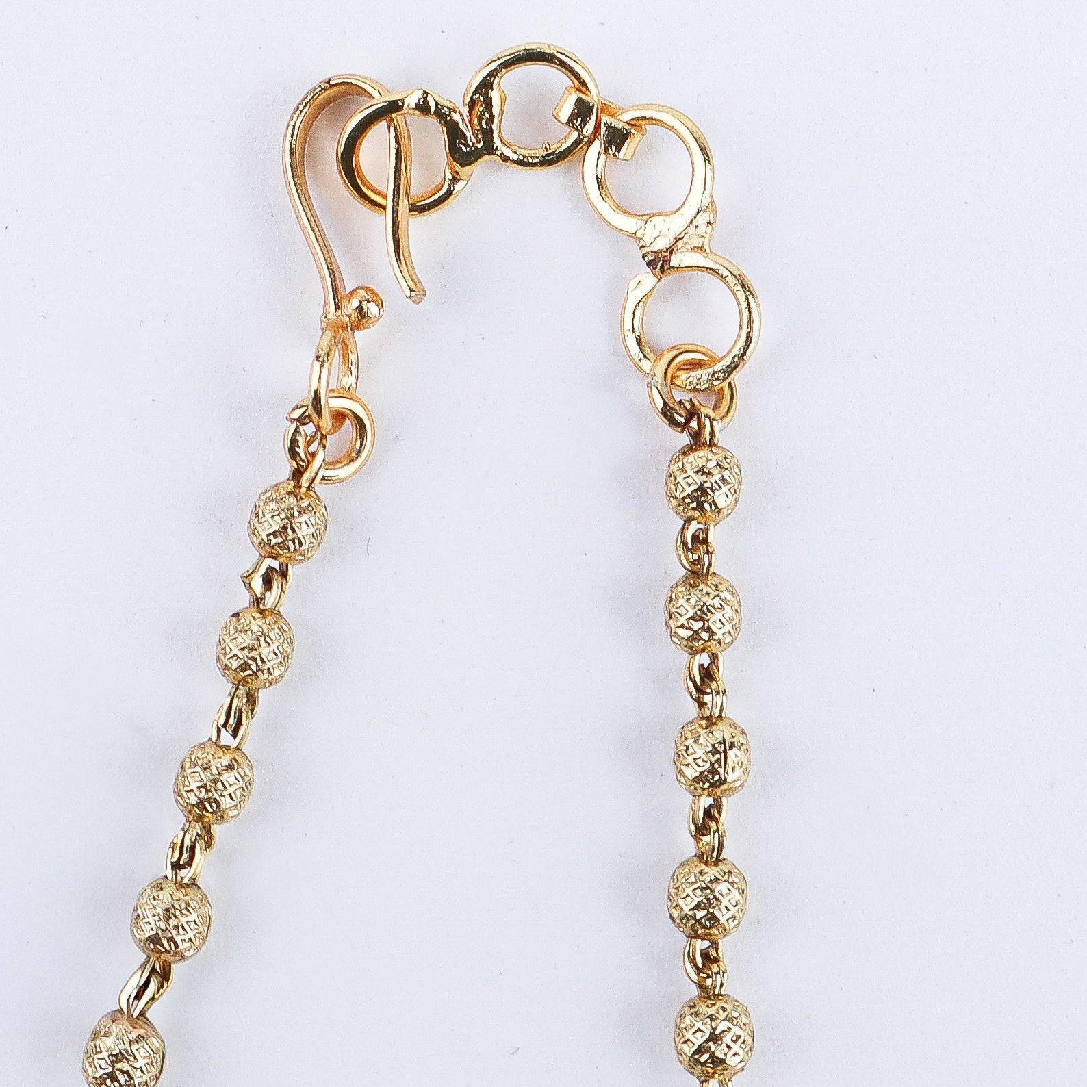 Angled view of the 22K gold-plated fashion set highlighting its coordinated design, elegant structure, and polished gold finish