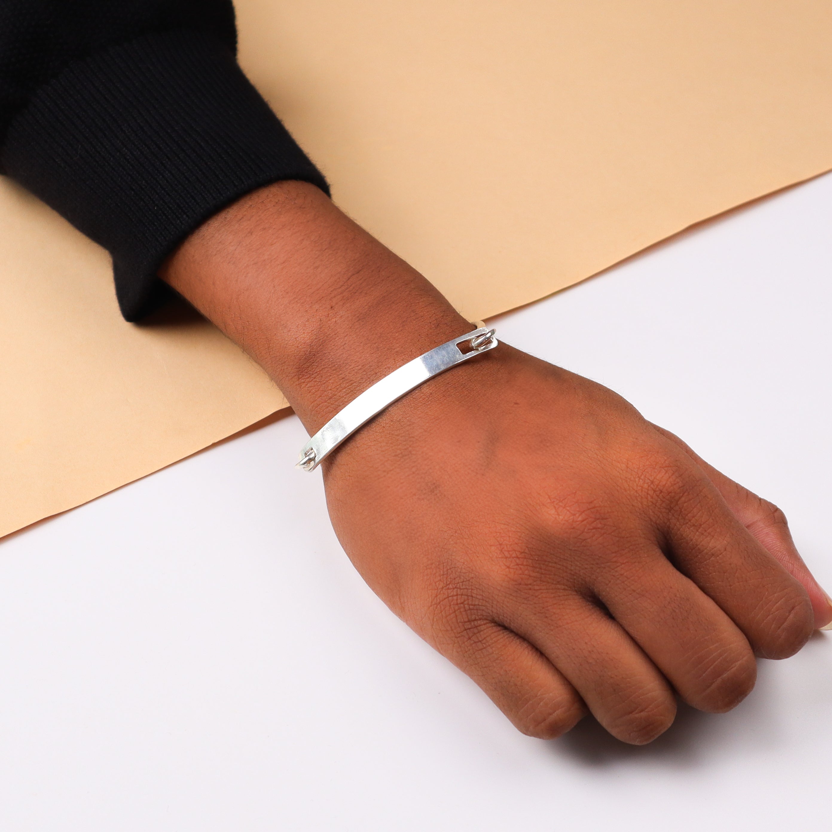 Silver unisex bracelet on wrist
