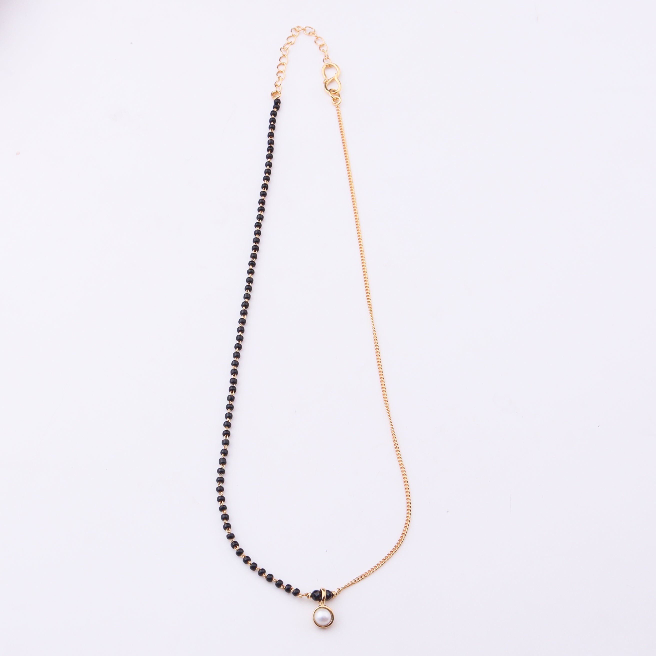 Gold and black beaded necklace with pearl pendant