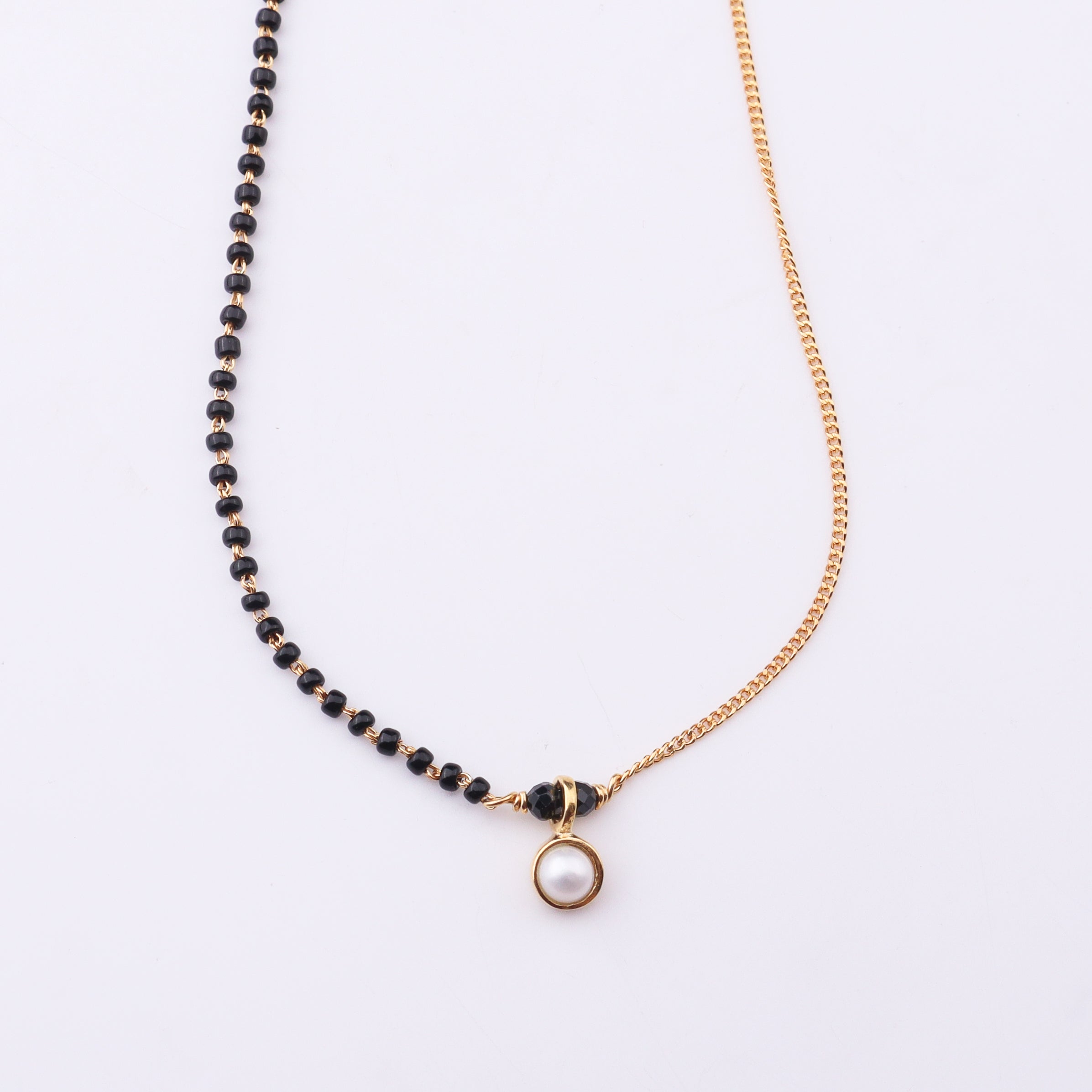 Gold and black beaded mangalsutra with pearl pendant