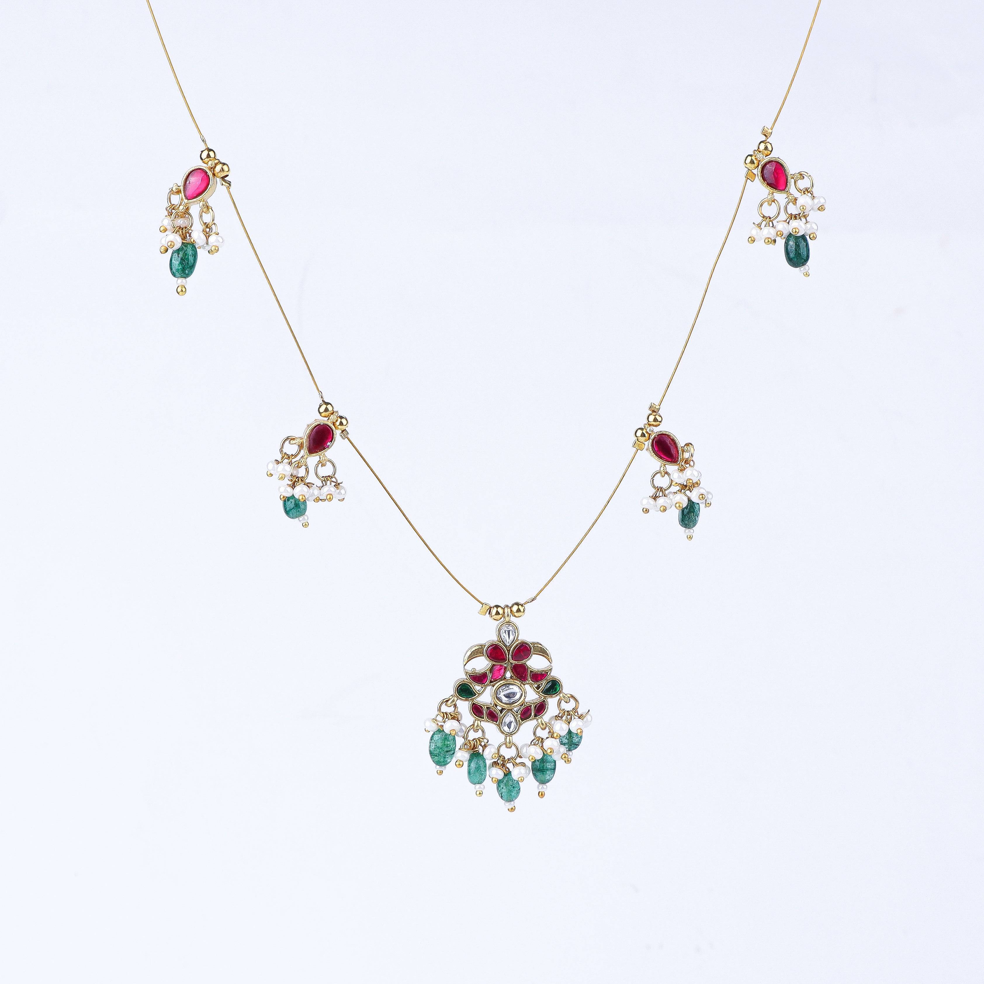 Flat-lay of 22K gold-plated fashion necklace with complementary gold-plated jewellery and elegant accessories