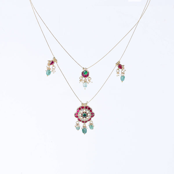 Flat-lay of a 22K gold-plated fashion necklace with complementary gold-plated jewelry and elegant accessories