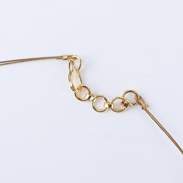 Angled view of a 22K gold-plated fashion necklace highlighting its elegant structure, unique design, and polished gold finish