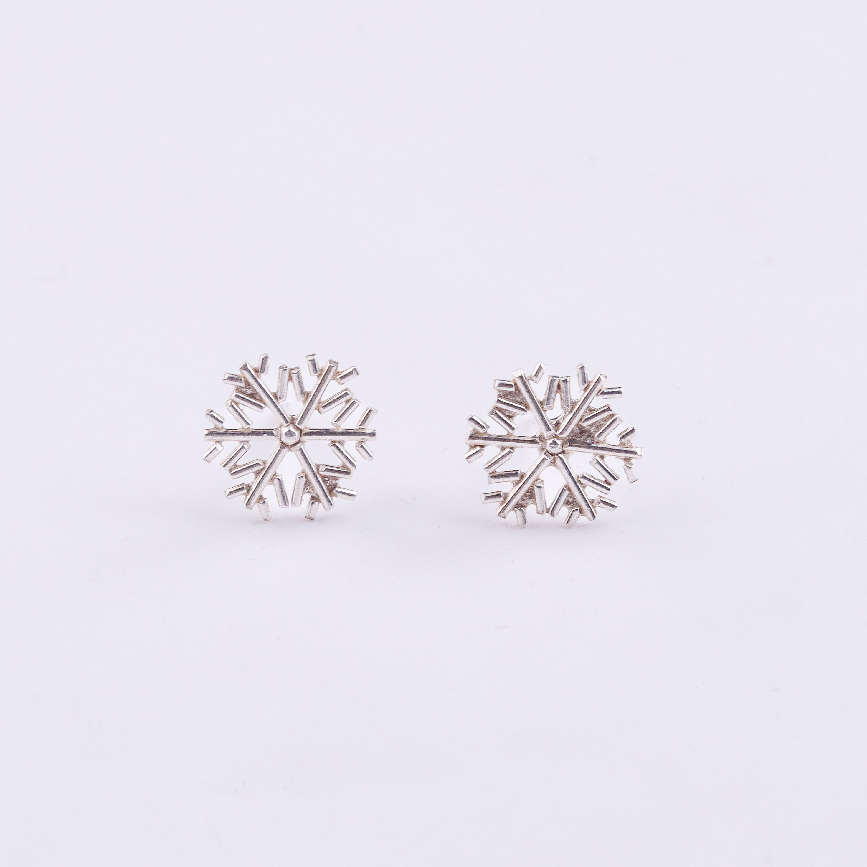 Silver snowflake earrings close-up