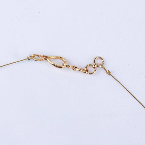 Angled view of a 22K gold-plated fashion necklace highlighting its elegant structure, design, and polished gold finish
