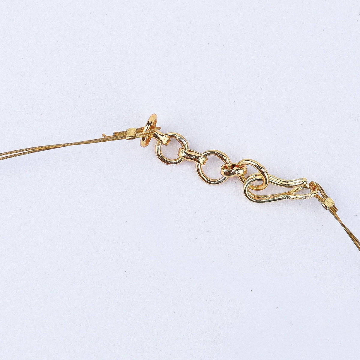 Angled view of a 22K gold-plated fashion necklace highlighting its elegant structure, unique design, and polished gold finish