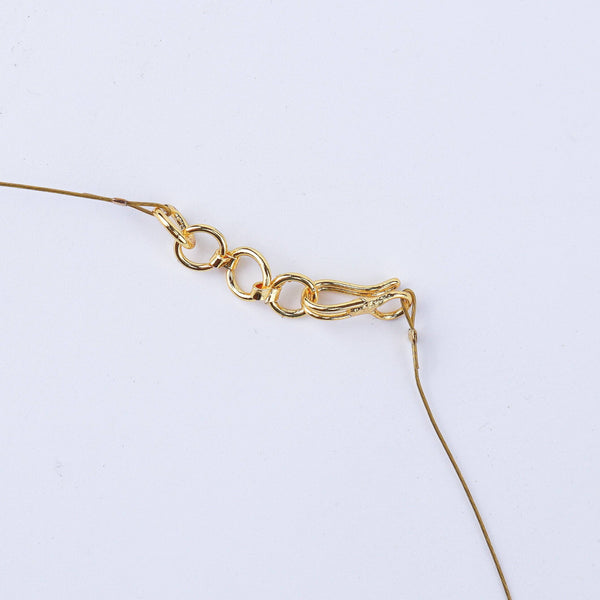 Angled view of a 22K gold-plated fashion necklace highlighting its elegant structure, unique design, and polished gold finish