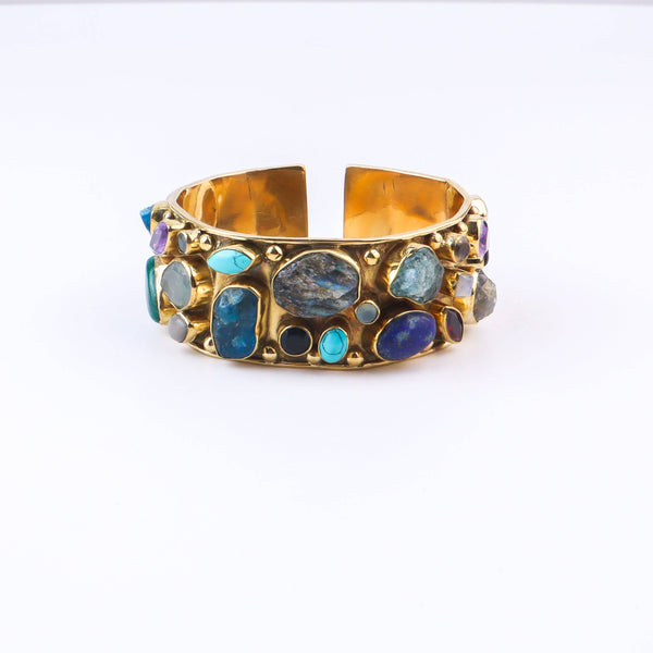 Detailed view of a brass fashion bracelet highlighting intricate motifs, textured surface, and refined brass finish