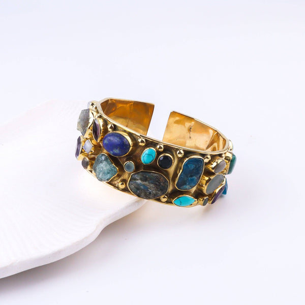 Close-up of a brass fashion bracelet showcasing intricate detailing, textured elements, and fine craftsmanship
