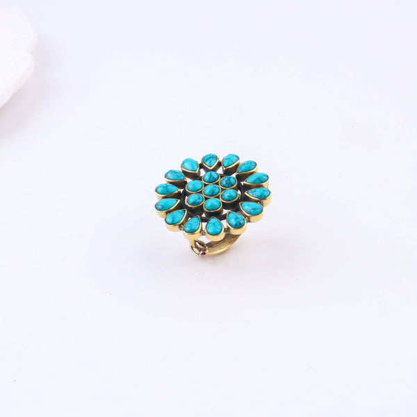 Detailed view of a brass fashion ring highlighting intricate motifs, textured surface, and refined brass finish