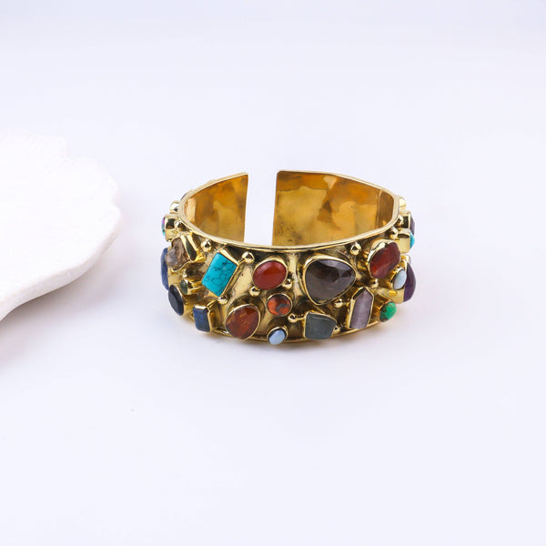 Close-up of a brass fashion bracelet showcasing intricate detailing, textured elements, and fine craftsmanship