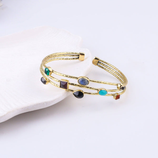 Close-up of a brass fashion bracelet showcasing intricate detailing, textured elements, and fine craftsmanship