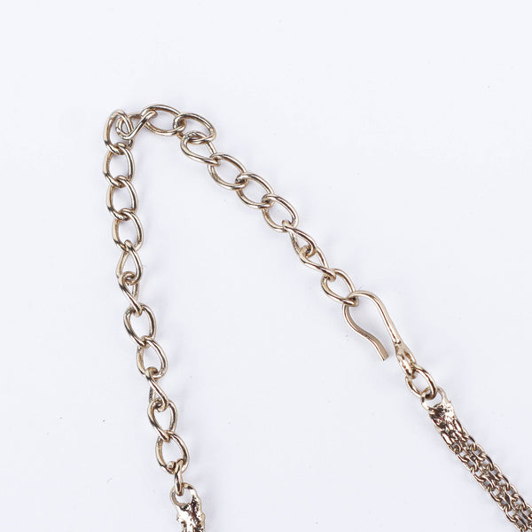 Angled view of a 22K gold-plated fashion necklace highlighting its elegant structure, unique design, and polished gold finish