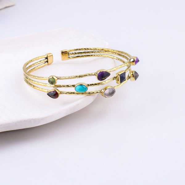 Close-up of a brass fashion bracelet showcasing intricate detailing, textured elements, and fine craftsmanship