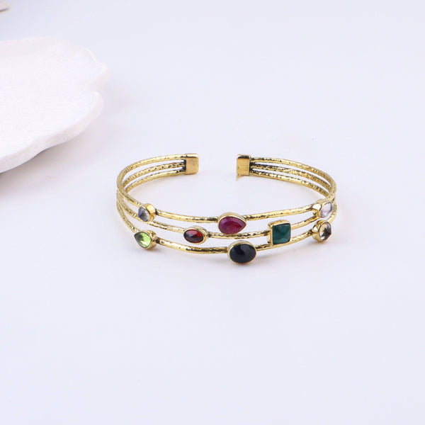 Close-up of a brass fashion bracelet showcasing intricate detailing, textured elements, and fine craftsmanship