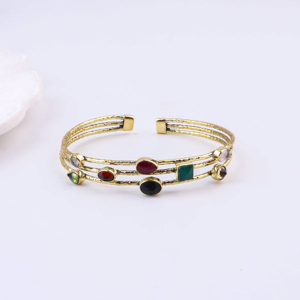 Close-up of a brass fashion bracelet showcasing intricate detailing, textured elements, and fine craftsmanship