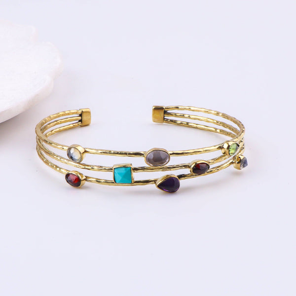 Close-up of a brass fashion bracelet showcasing intricate detailing, textured elements, and fine craftsmanship