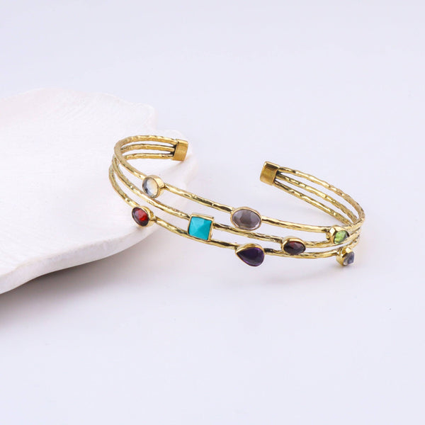 Detailed view of the brass fashion bracelet highlighting intricate motifs, textured surface, and refined brass finish