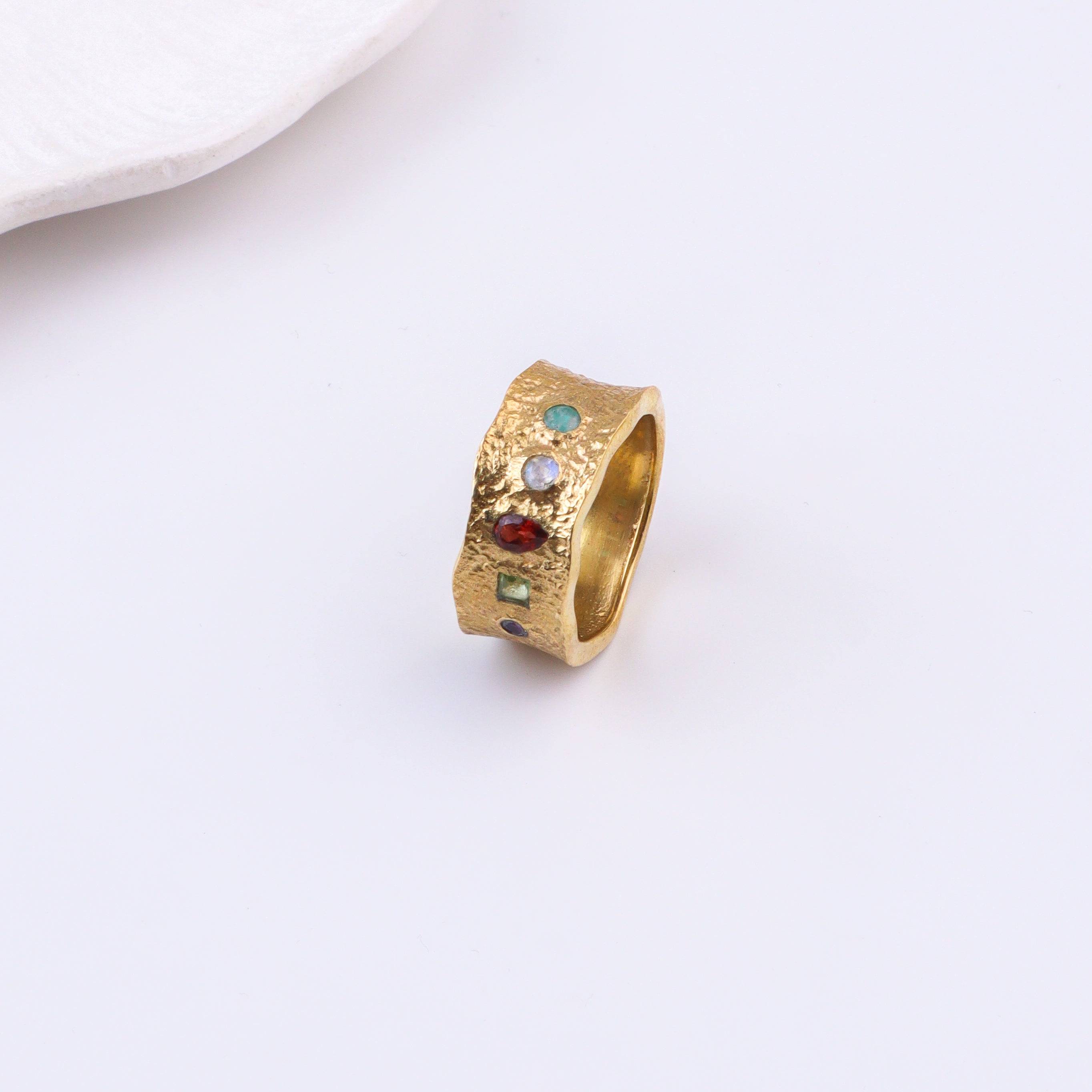 Angled view of a brass fashion ring highlighting its distinctive shape, structure, and polished brass finish