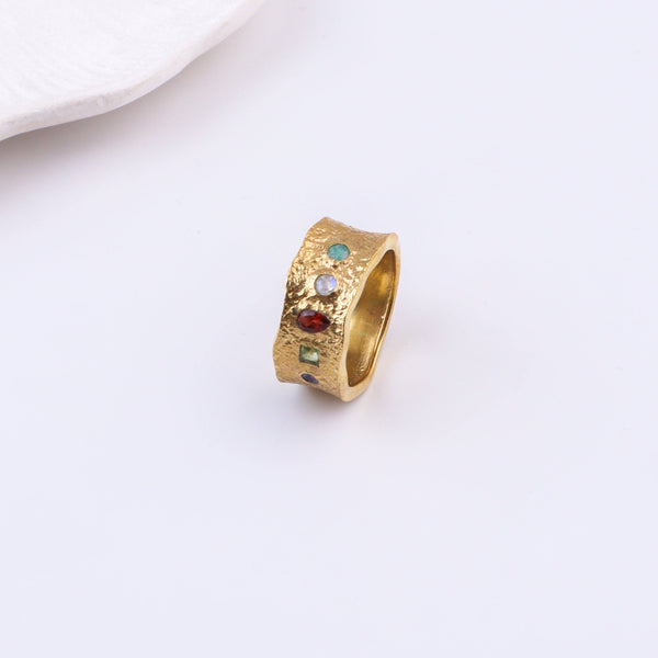 Angled view of a brass fashion ring highlighting its distinctive shape, structure, and polished brass finish