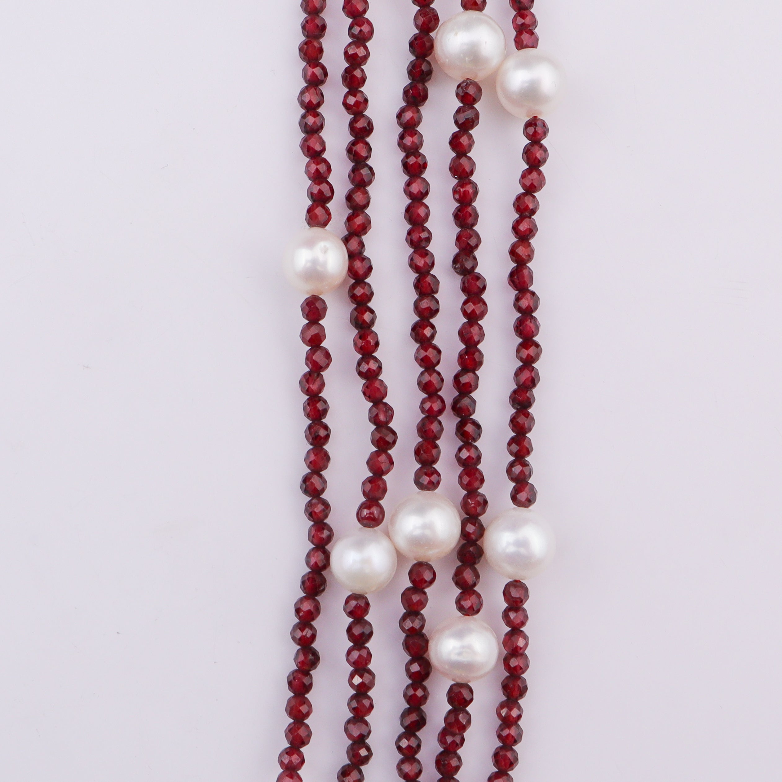 Red beaded necklace with large white pearls